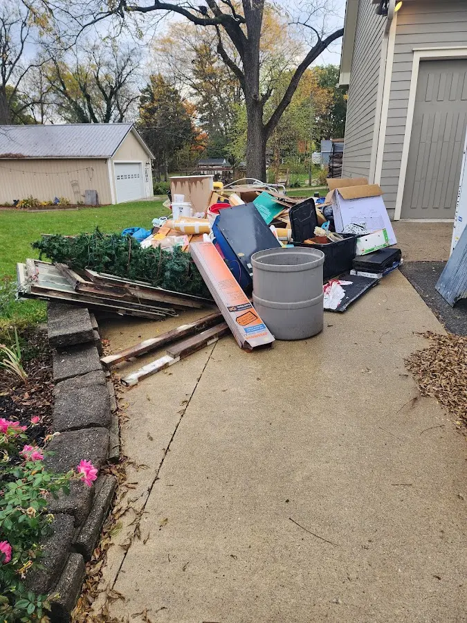 Dumpster being loaded with debris for Roofing Dumpster Rental in Camanche